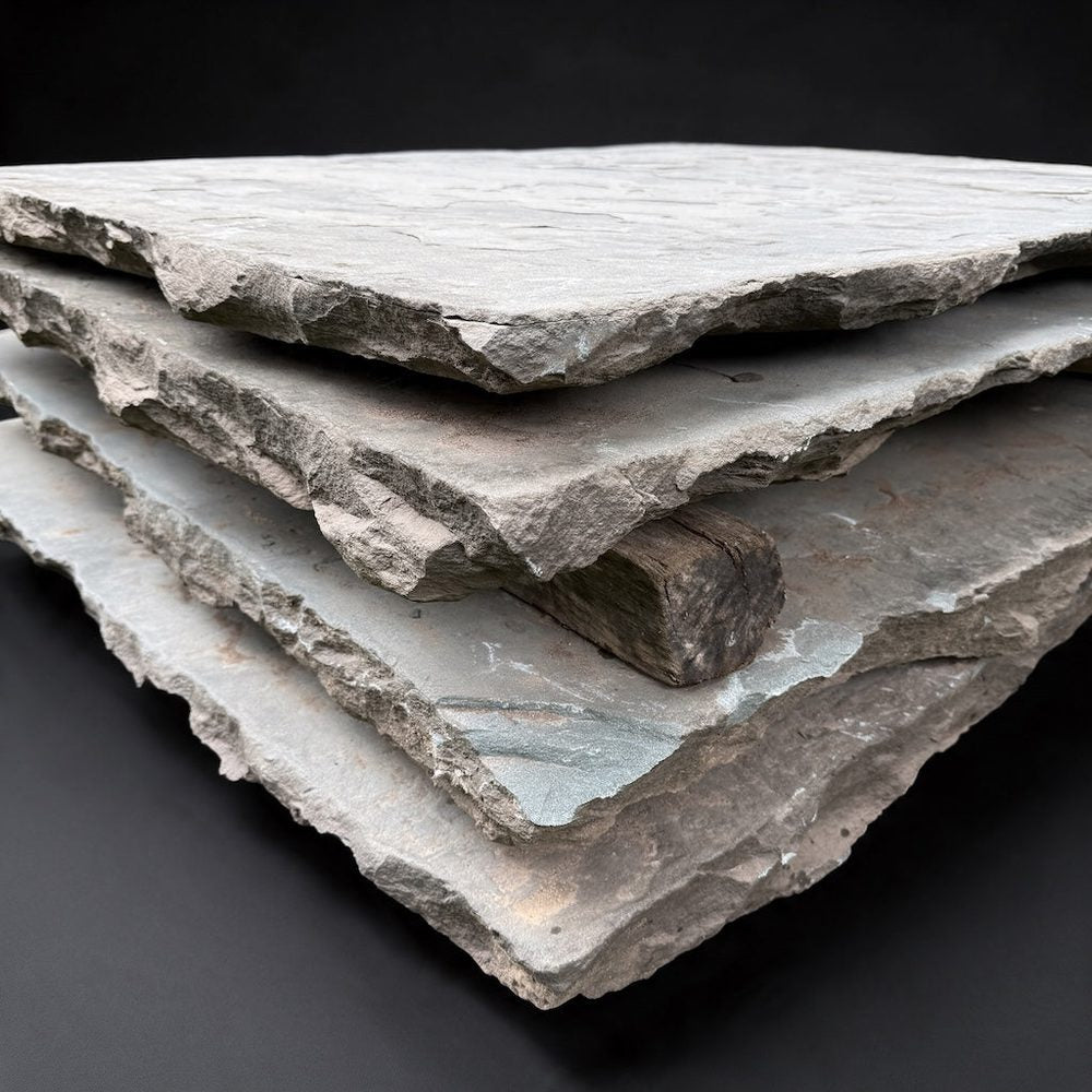 Angled close-up of weathered bluestone pavers with broken edges