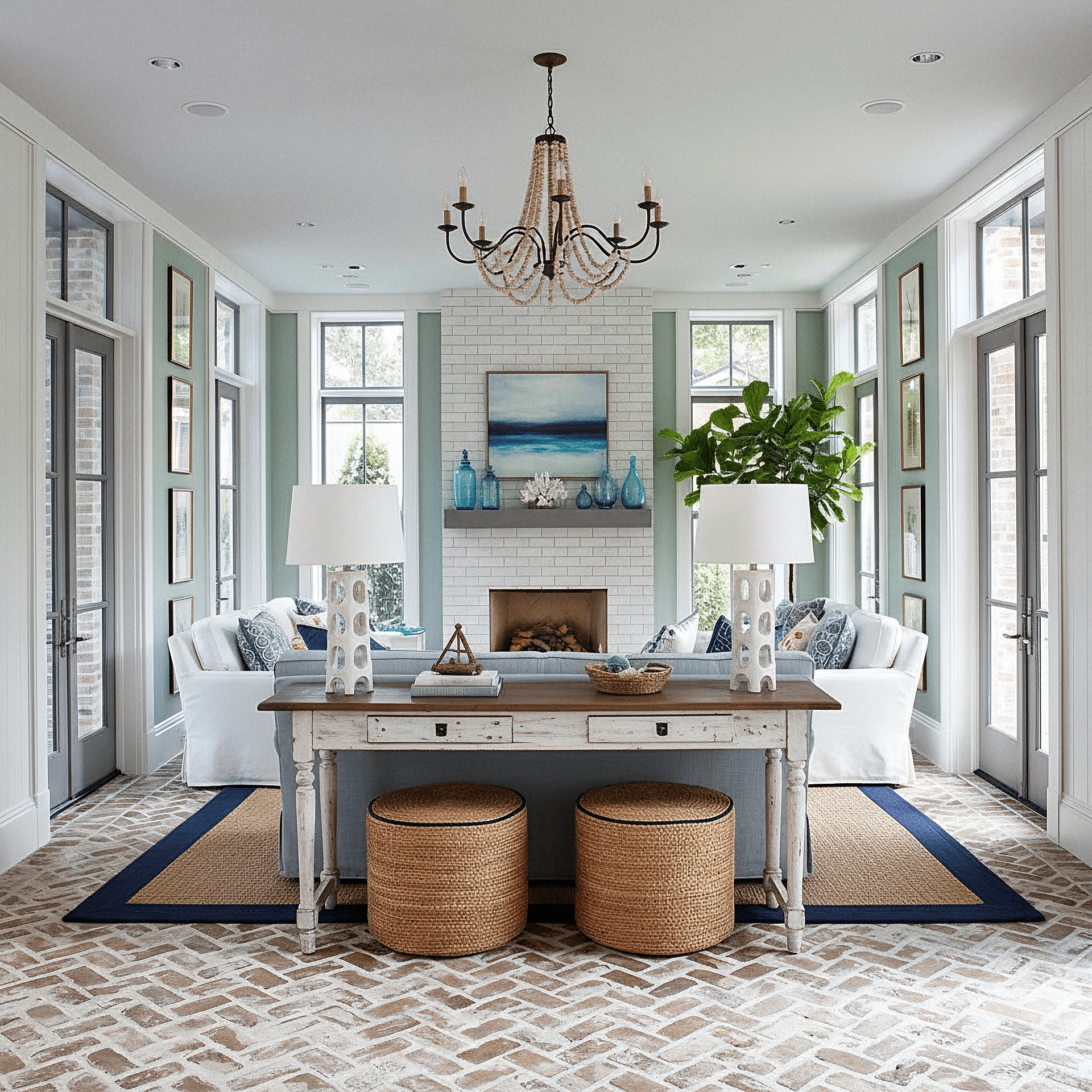 Living room with a wooden coffee table, chairs, and reclaimed floor tiles