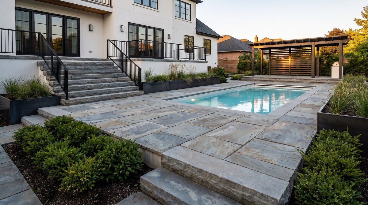 Reclaimed bluestone slab patio around a backyard pool, with thick bluestone curbstone steps and boxwood plantings