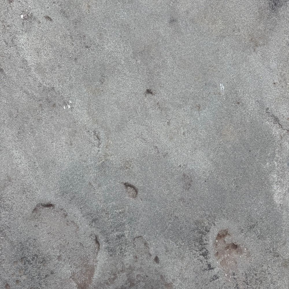 Close-up of grainy matte bluestone surface with historic character